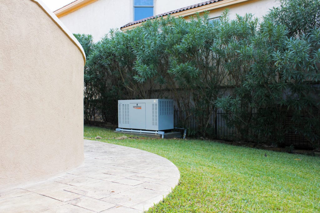 Whole house standby generator installed beside a home.