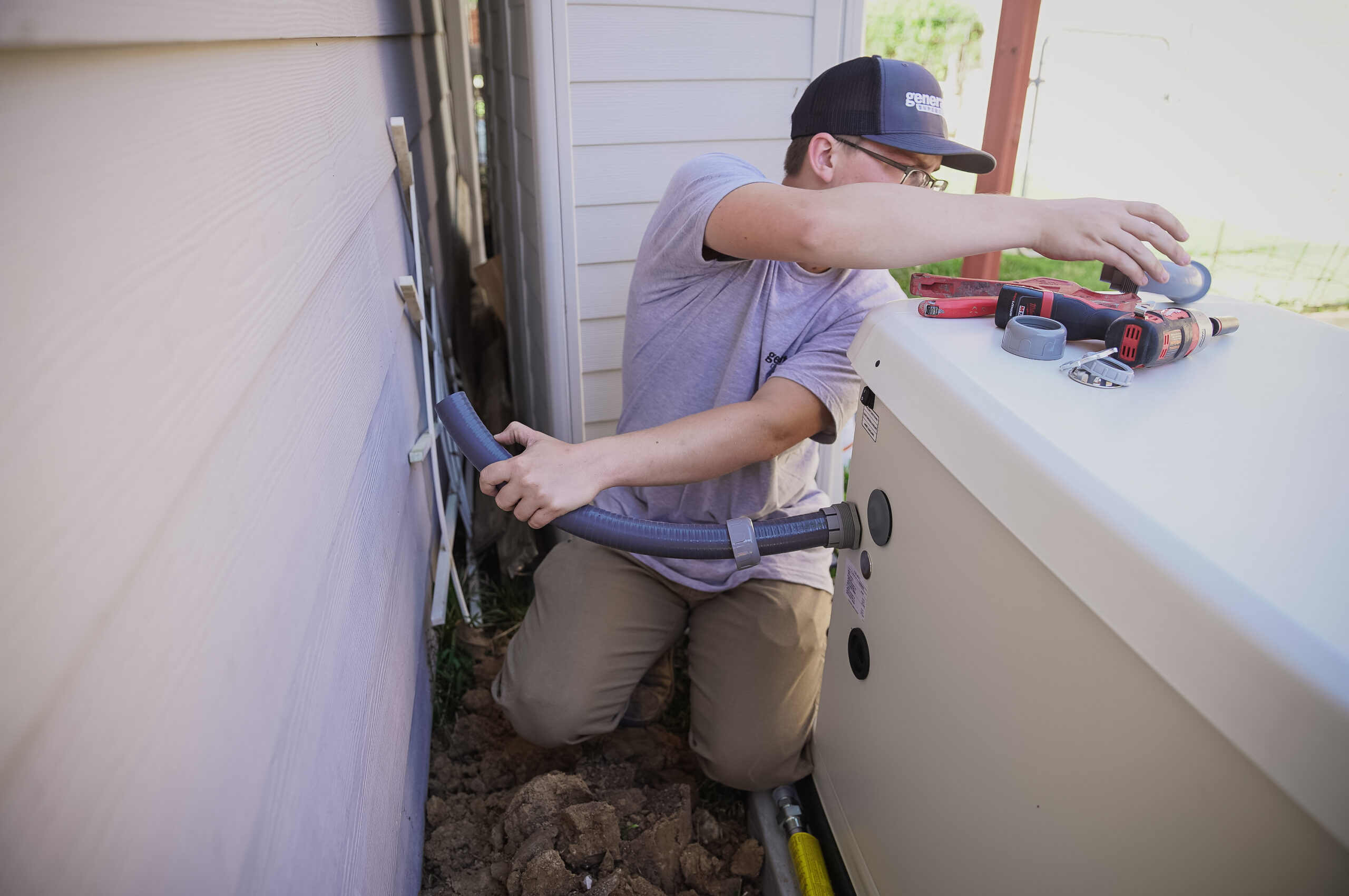 Technician installing a transfer switch for a home standby generator