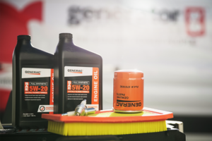Generac generator oil, filter, and maintenance supplies on a table.