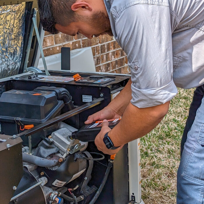 Technician servicing a standby generator outdoors