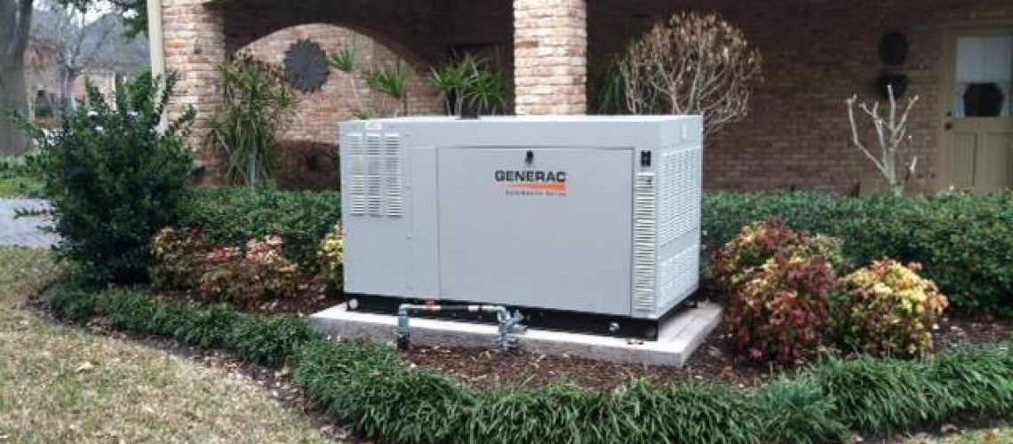 27kw Whole home standby generator installed in a landscaped front yard.