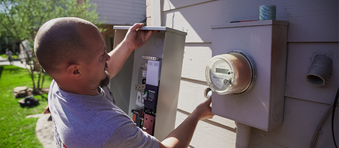 a man fixing an outdoor switch