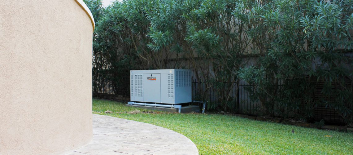 Whole house standby generator installed beside a home.
