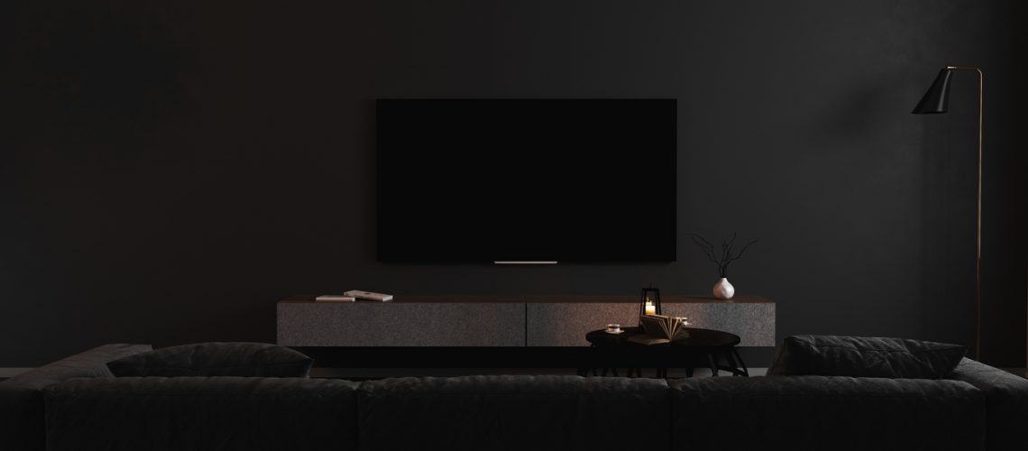 Blank TV screen in modern dark interior with gray sofa in darkness mock up, front view. TV in living room interior background, empty TV display template, 3d render