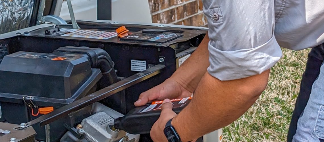 Technician servicing a standby generator outdoors
